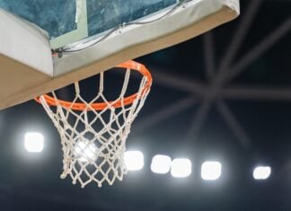 Basketball hoop hanging in a sports stadium waiting for the ball